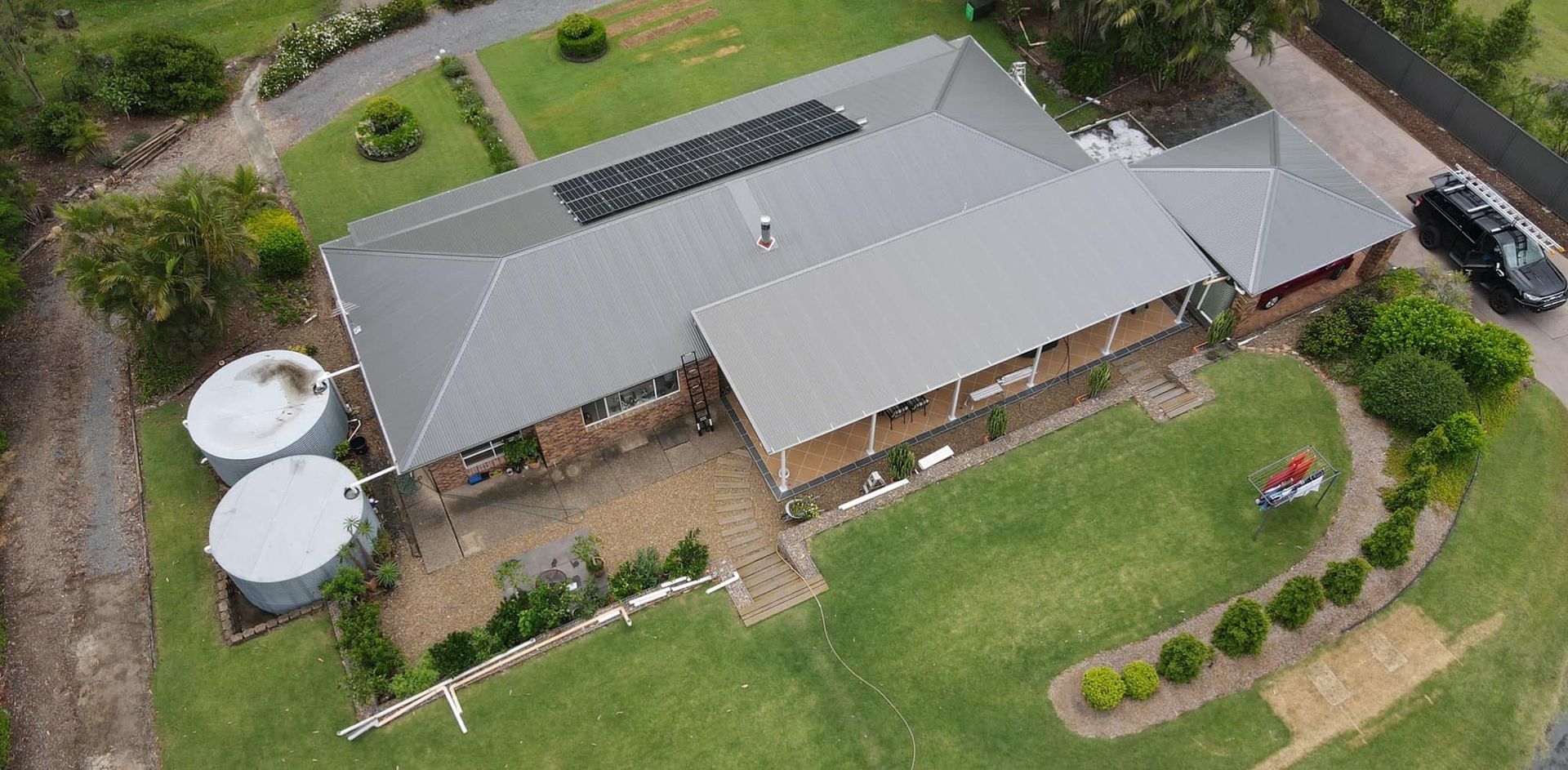 Aerial View of a House With a Gray Roof and Solar Panels — Over the Top Roofing Specialists in Deception Bay, QLD