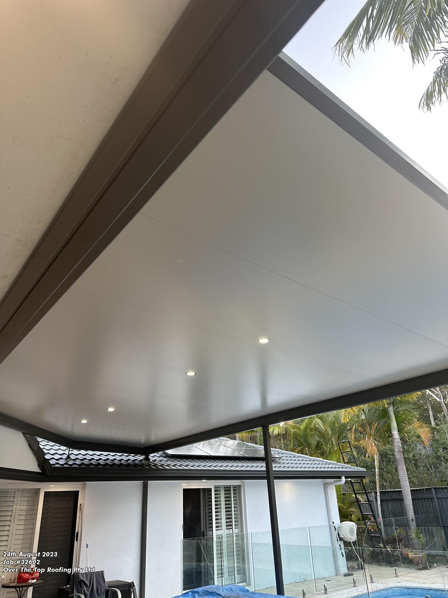 Patio Cover With Recessed Lights, Overlooking a House With a Pool — Over the Top Roofing Specialists in Deception Bay, QLD
