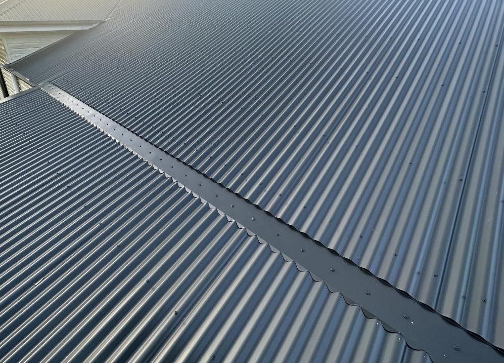 Dark Gray Corrugated Metal Roof With a Seam Down the Middle — Over the Top Roofing Specialists in Deception Bay, QLD