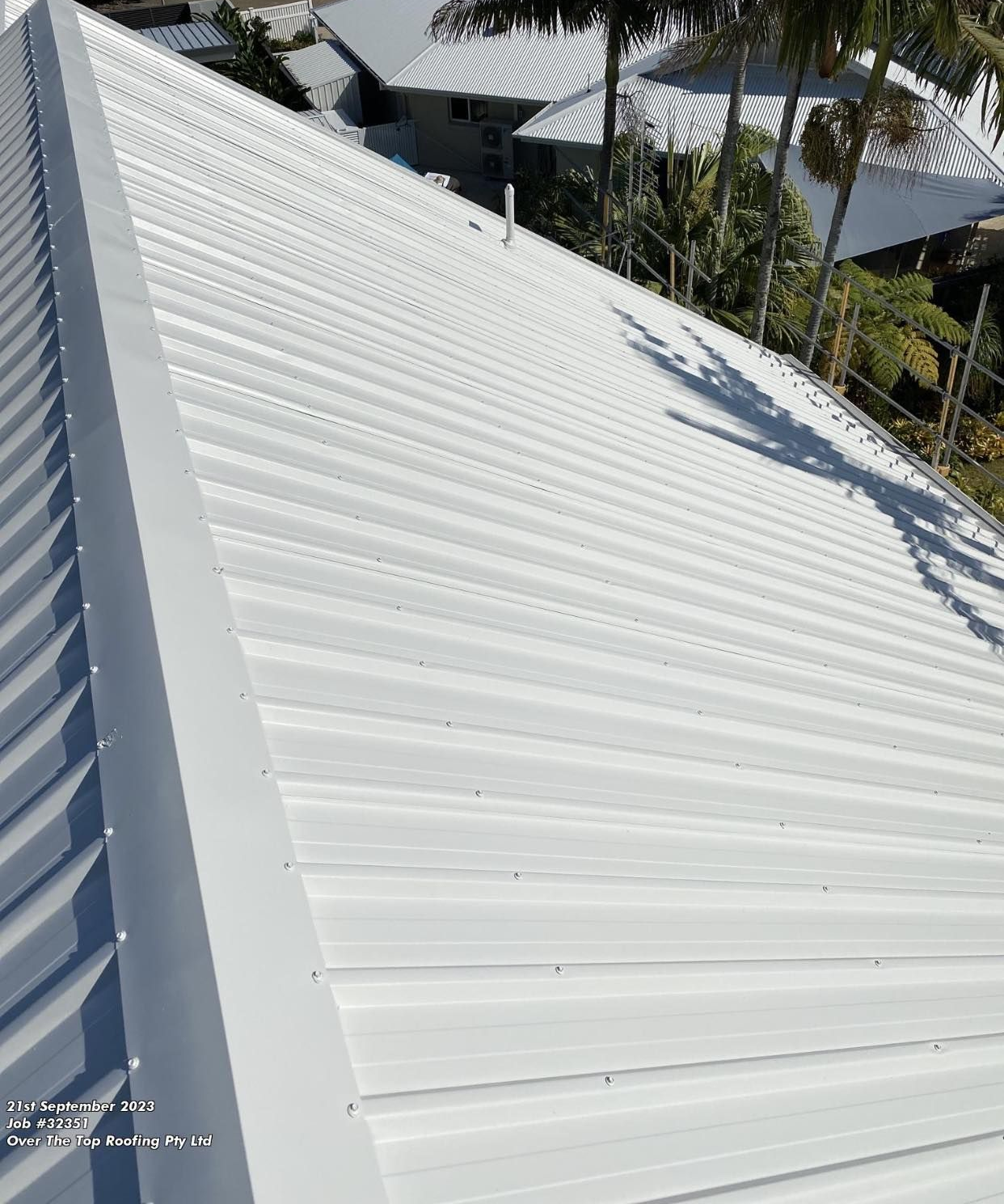 White Corrugated Metal Roof on a Building, Angled View — Over the Top Roofing Specialists in Buderim, QLD