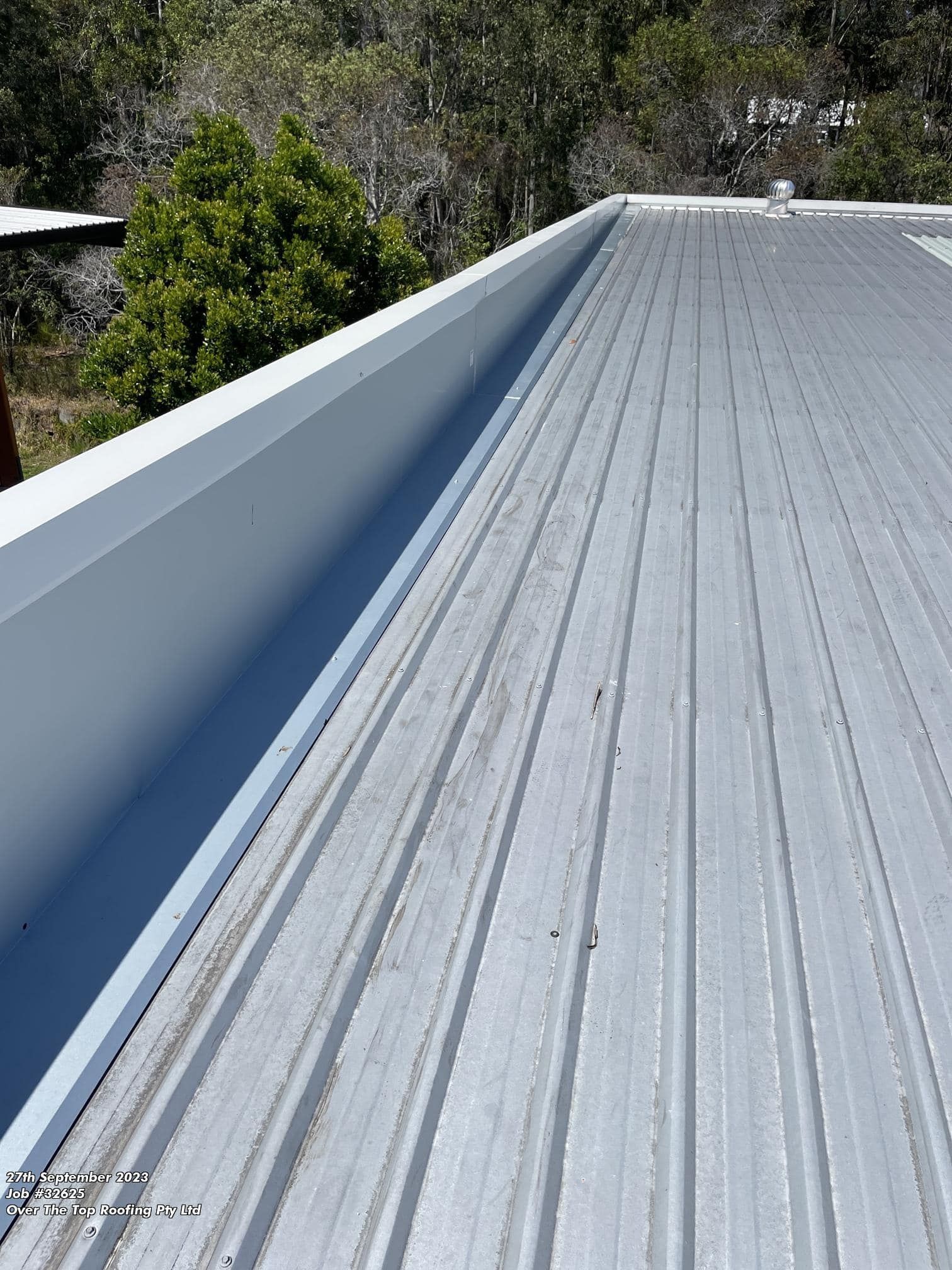 Metal Roof With Gutter, Likely on a Residential Building — Over the Top Roofing Specialists in Caboolture, QLD