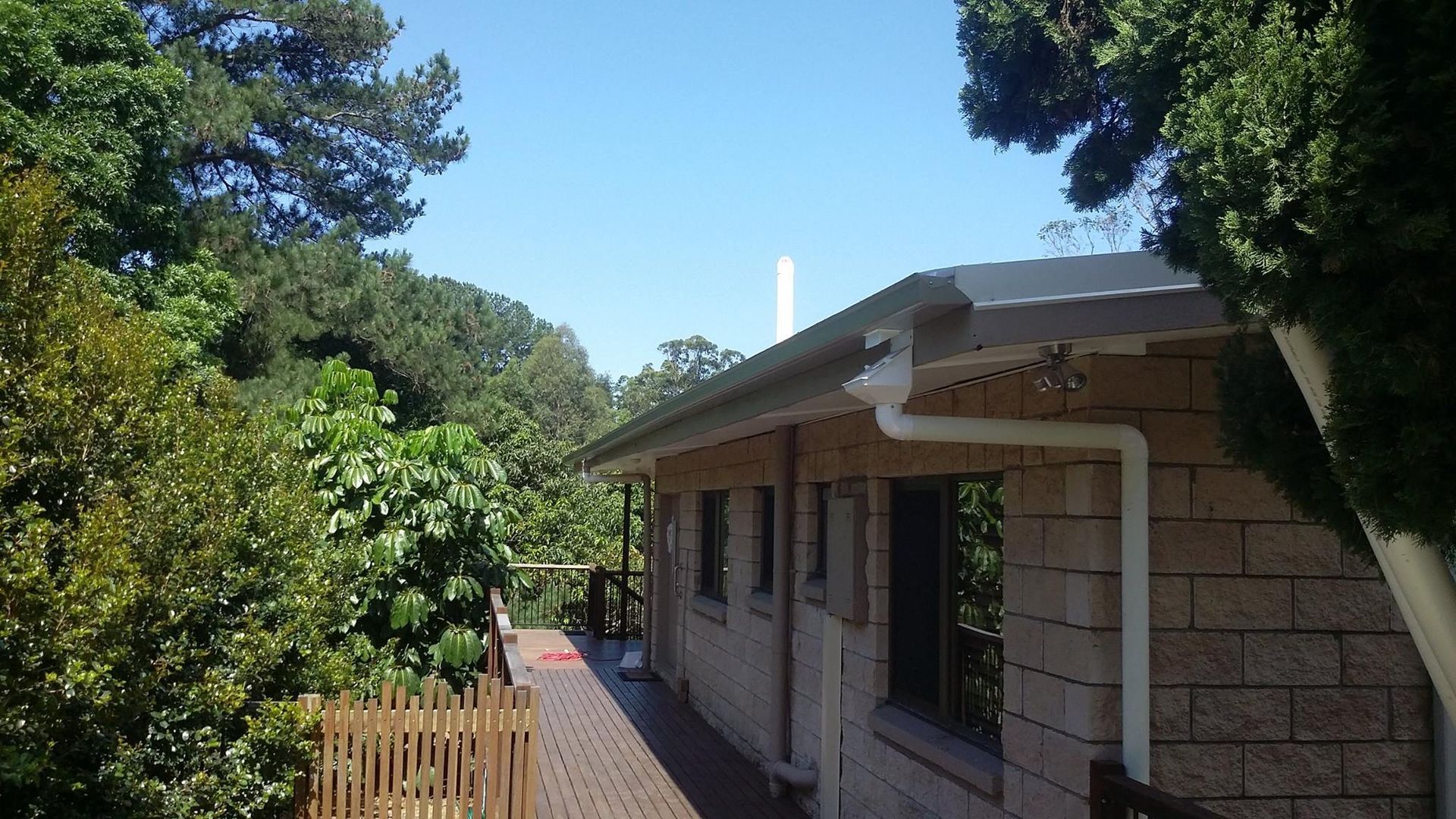 Building With a Dark Roof and White Gutters — Over the Top Roofing Specialists in Maroochydore, QLD