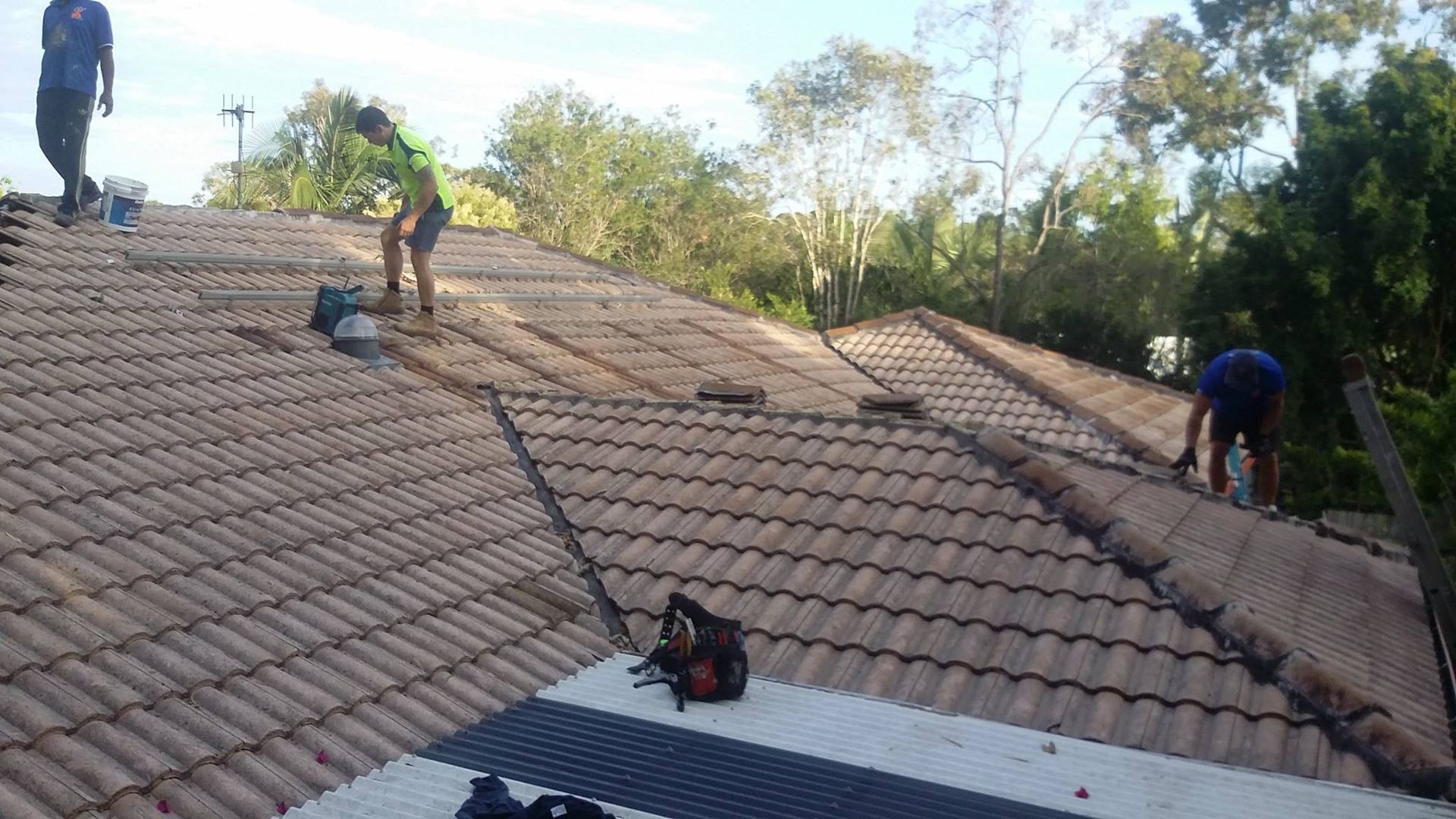 Workers on a Tiled Roof — Over the Top Roofing Specialists in Caloundra, QLD