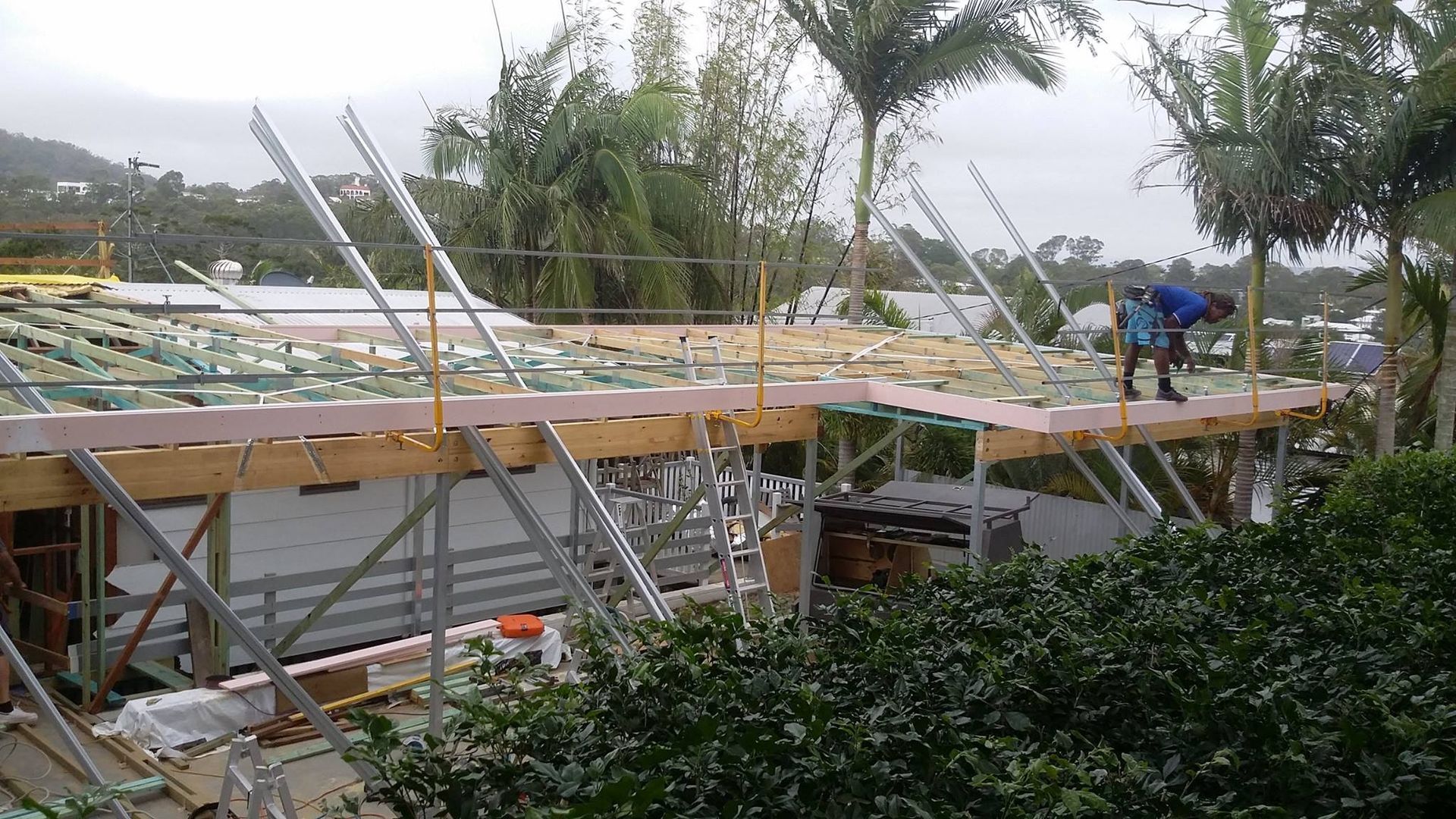 Construction Workers on a House Roof Supported by Scaffolding — Over the Top Roofing Specialists in Caloundra, QLD