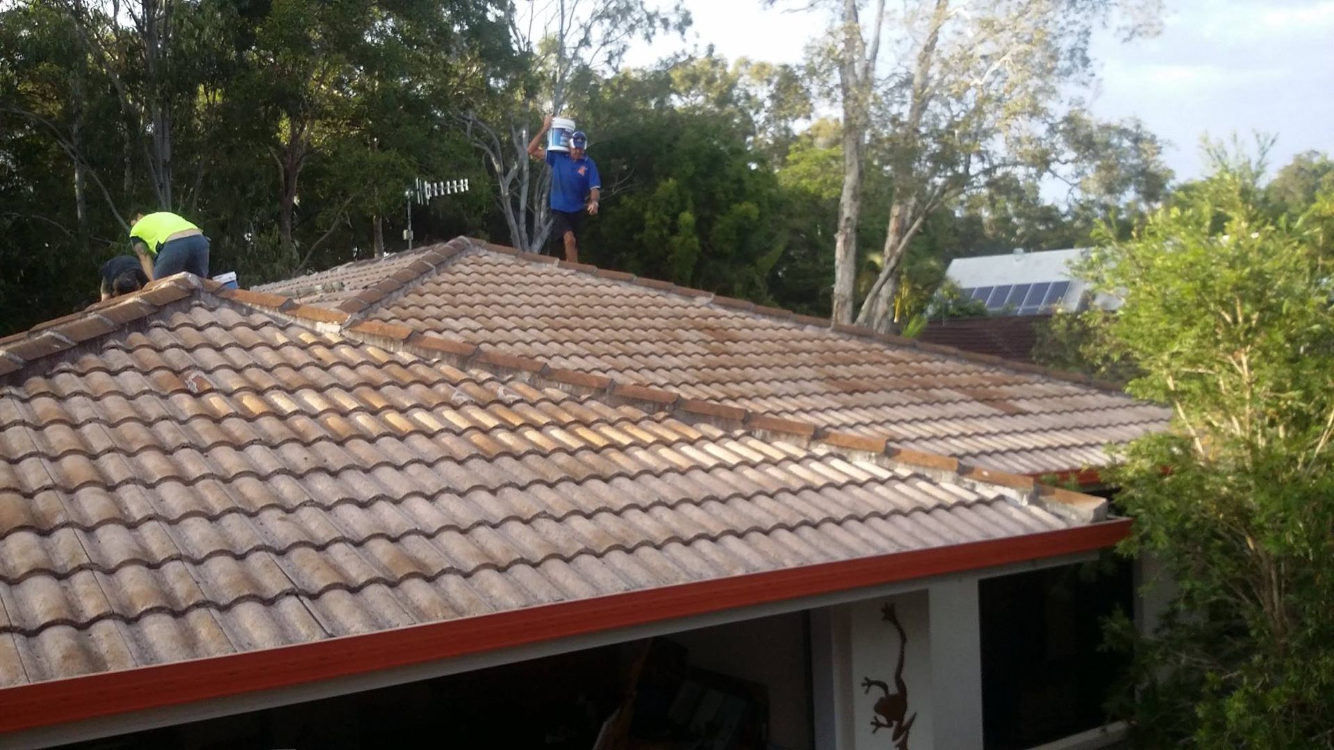 Two People on a Tiled Roof — Over the Top Roofing Specialists in Buderim, QLD