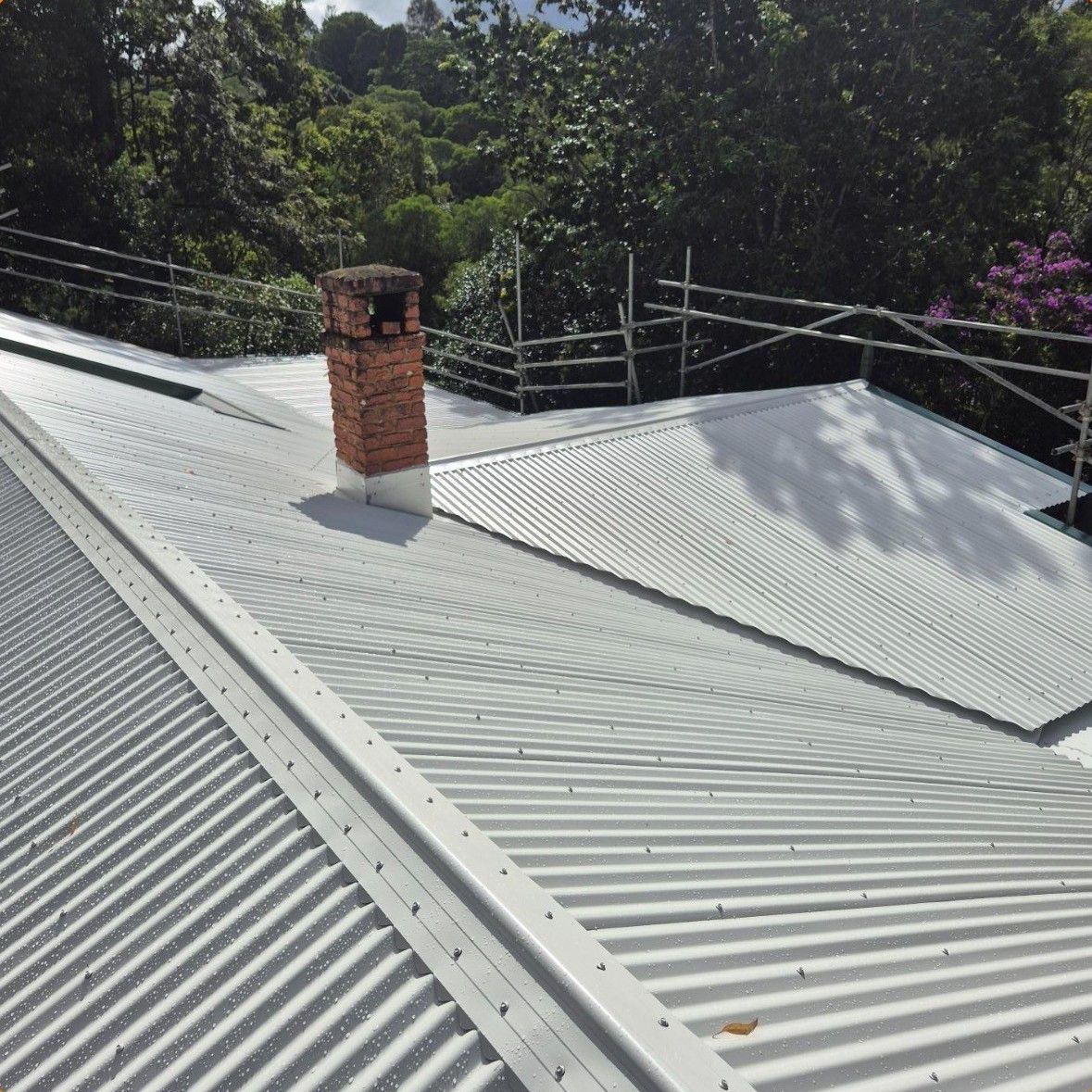 Corrugated Metal Roof With Chimney, Scaffolding — Over the Top Roofing Specialists in Morayfield, QLD