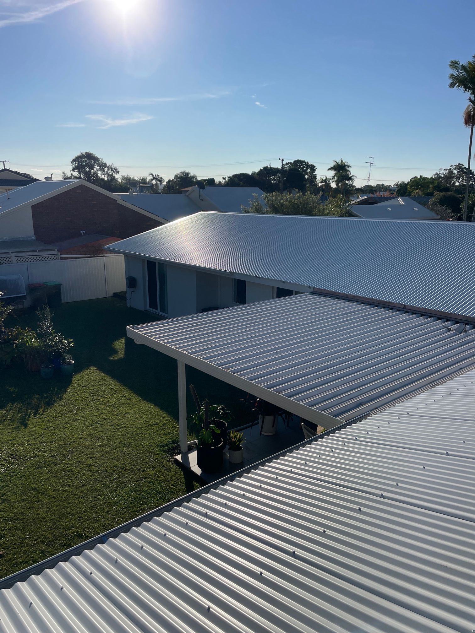 View of Several White Corrugated Metal Roofs — Over the Top Roofing Specialists in Kunda Park, QLD
