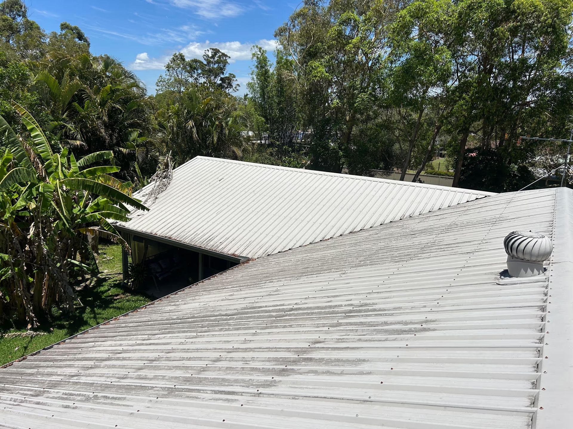 Gray Corrugated Metal Roof With Some Algae Growth — Over the Top Roofing Specialists in Kunda Park, QLD