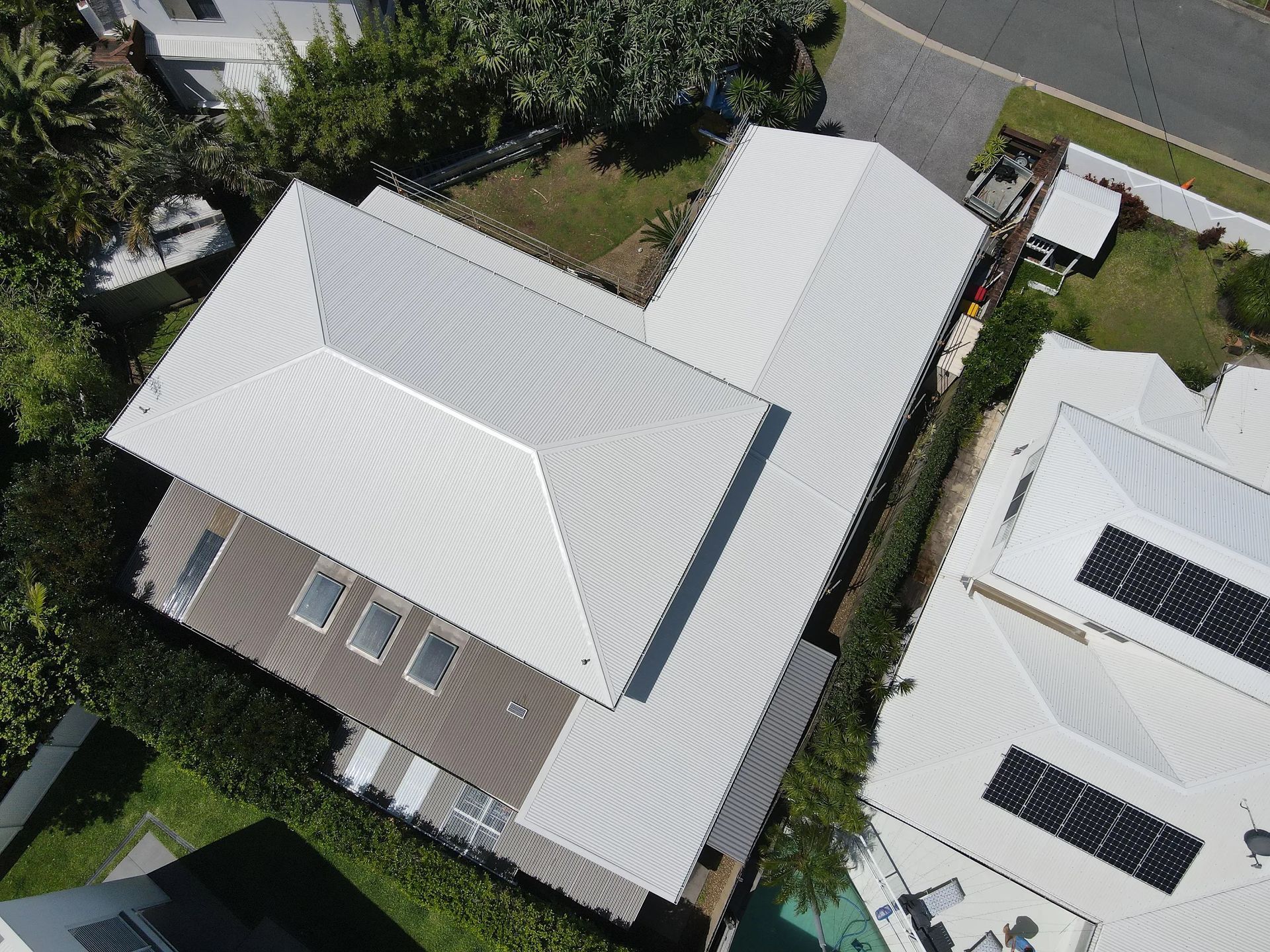 Aerial View of a House With a White Corrugated Metal Roof — Over the Top Roofing Specialists in Kunda Park, QLD
