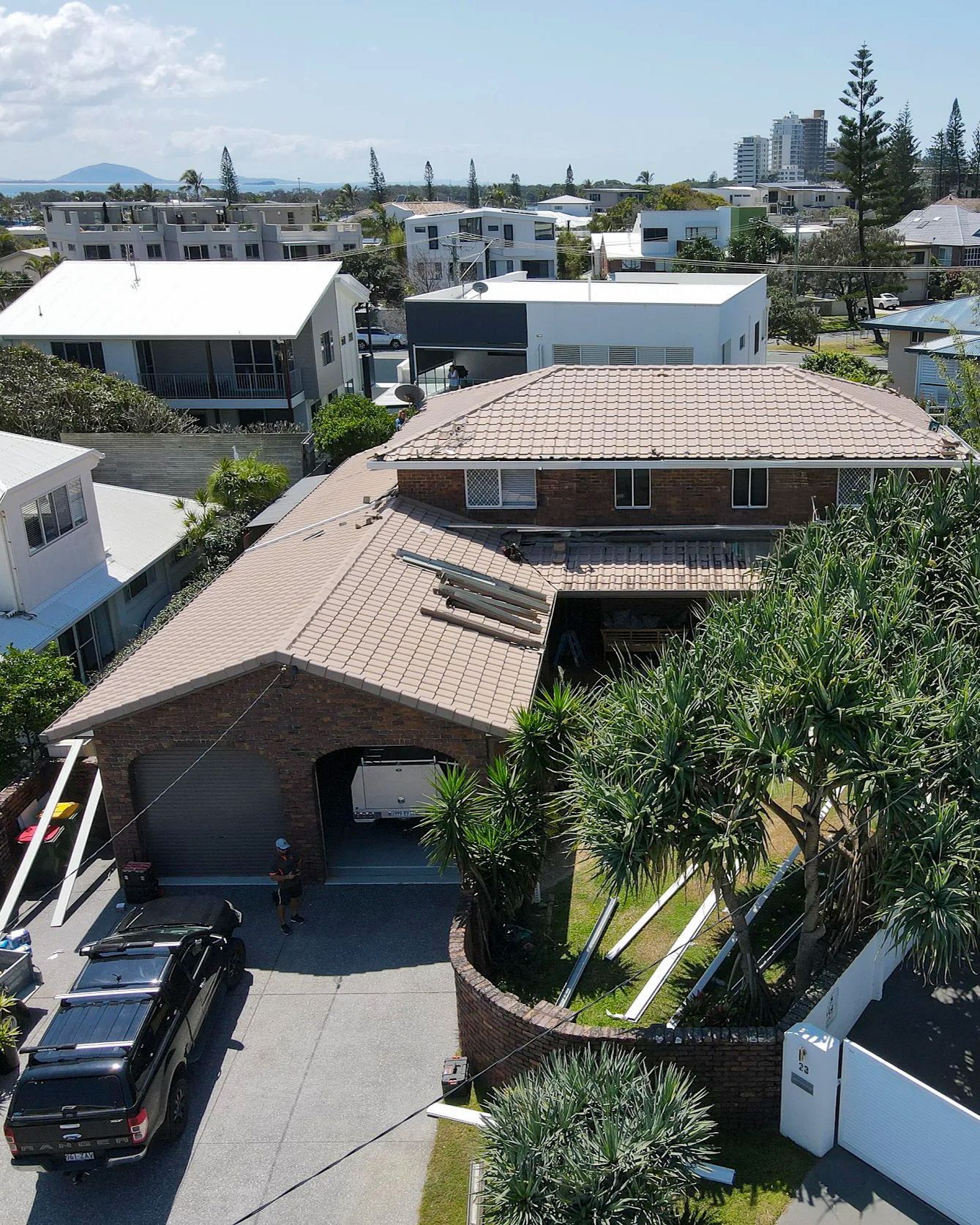 Aerial View of a Brown Brick House With a Tile Roof — Over the Top Roofing Specialists in Kunda Park, QLD