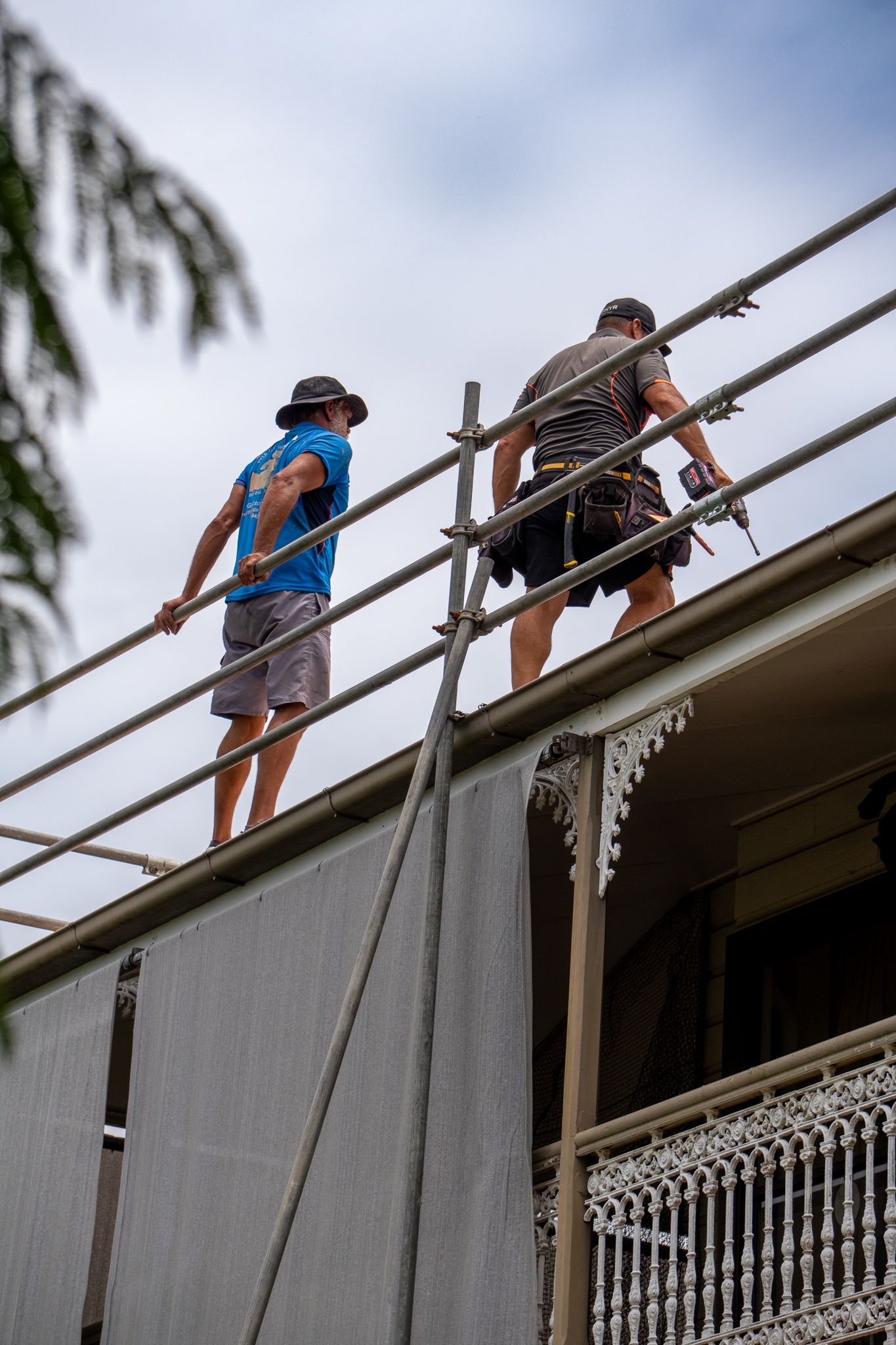 Two Construction Workers on a Rooftop — Over the Top Roofing Specialists in Kunda Park, QLD