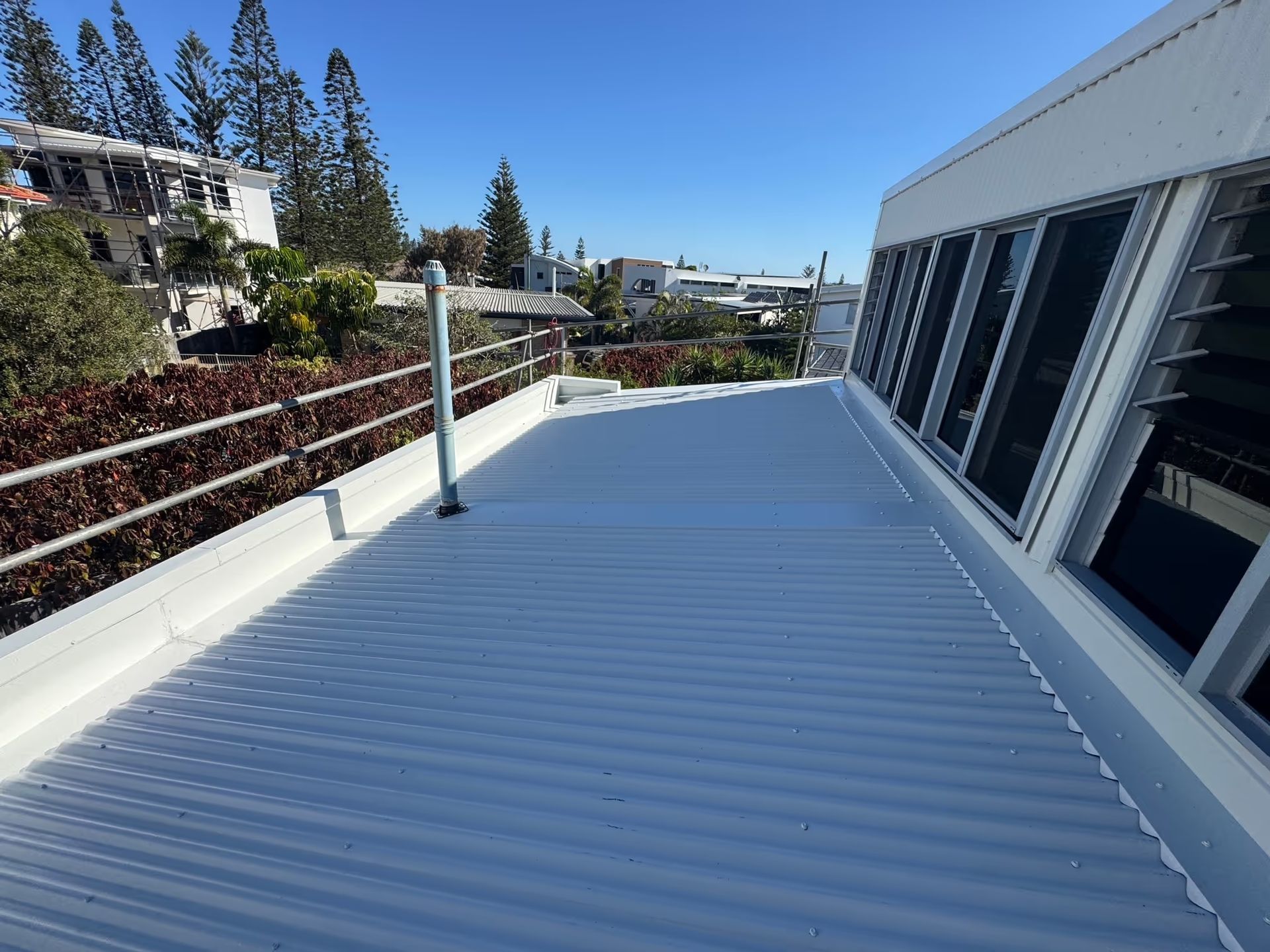 Exterior View of a White Corrugated Metal Roof — Over the Top Roofing Specialists in Kunda Park, QLD