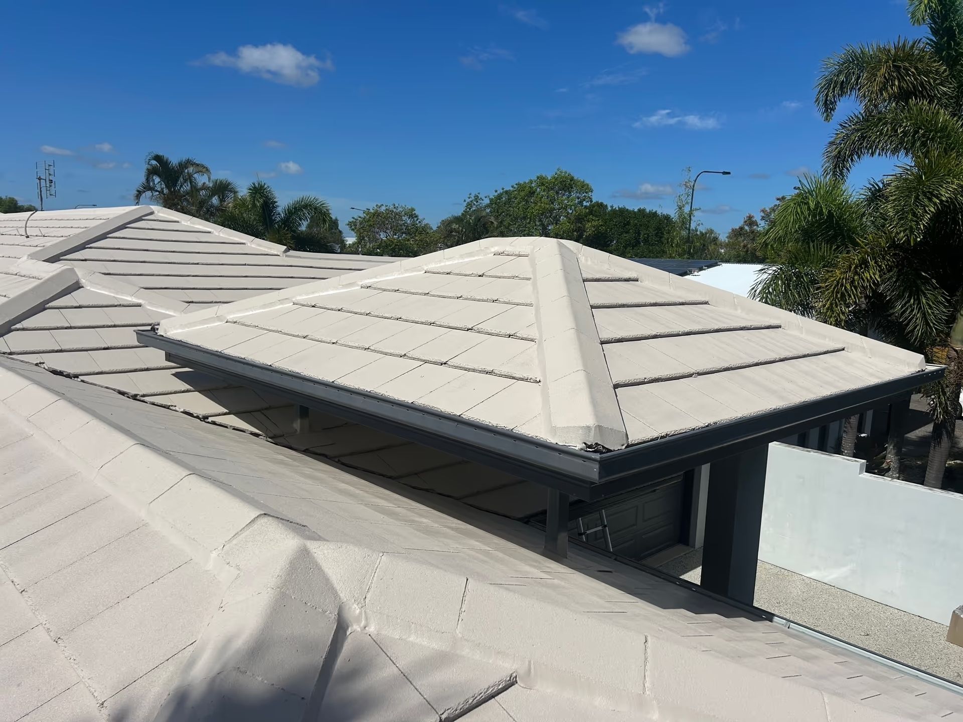 A Light-colored Tiled Roof With a Raised, Pyramid-shaped — Over the Top Roofing Specialists in Kunda Park, QLD