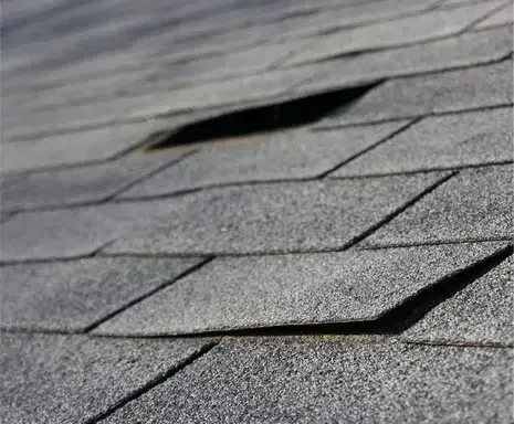 Close-up of Asphalt Shingles on a Roof With a Rectangular Hole — Over the Top Roofing Specialists in Narangba, QLD