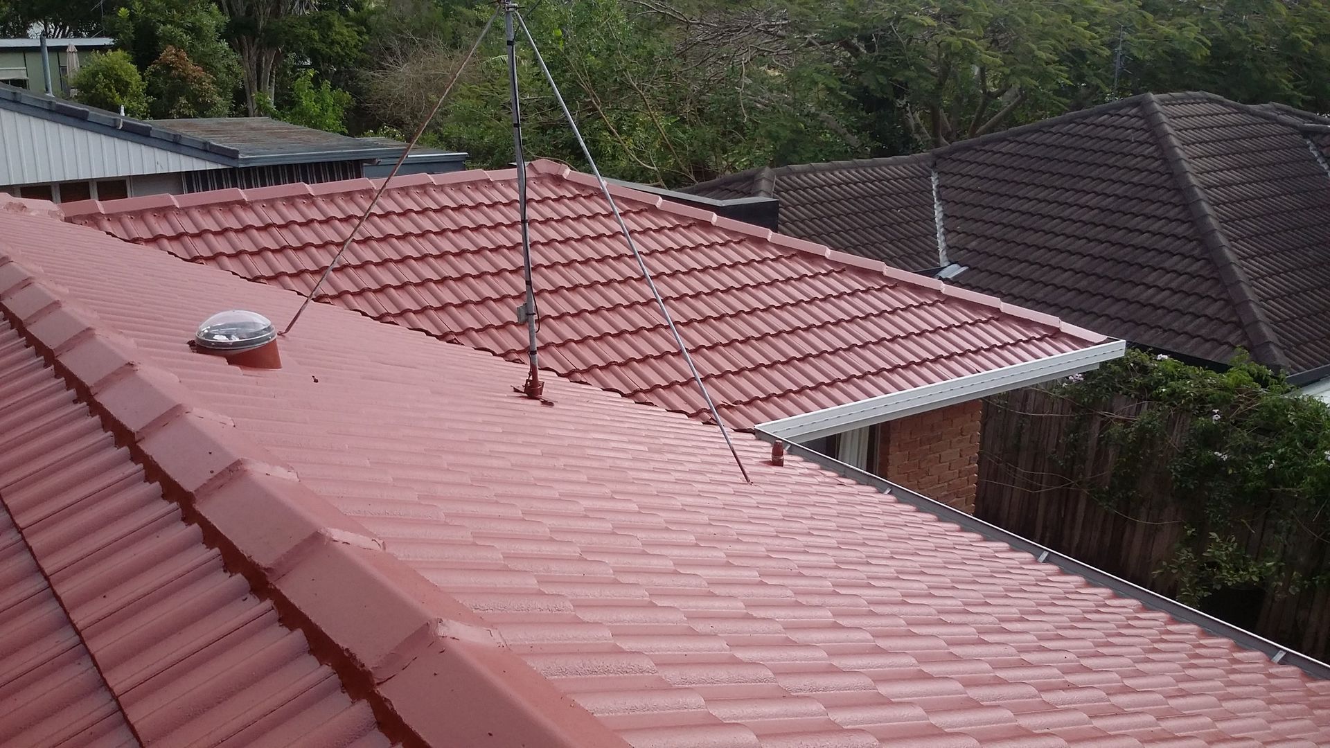 Red Tile Roof With a Lightning Rod and Other Roof Components — Over the Top Roofing Specialists in Nambour, QLD