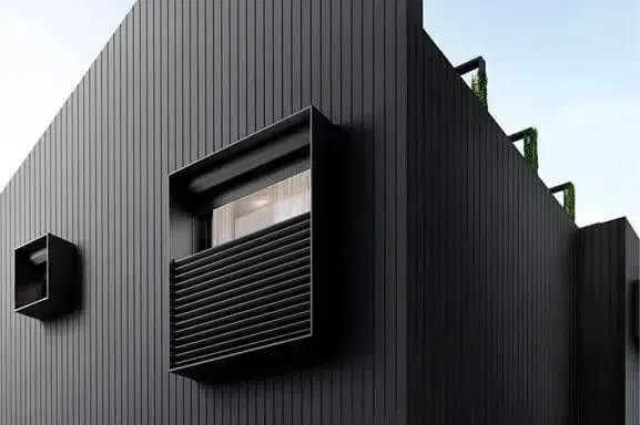 Black Modern Building Exterior With Vertical Siding — Over the Top Roofing Specialists in Kunda Park, QLD