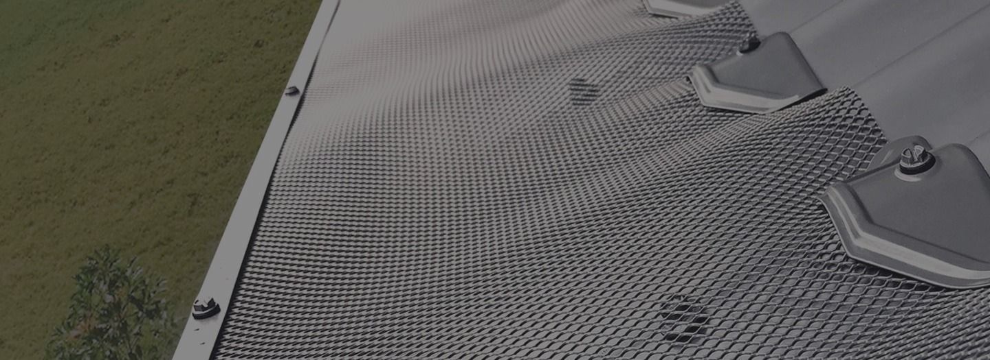 Metal Mesh Material Attached to a Roof With Brackets — Over the Top Roofing Specialists in North Lakes, QLD
