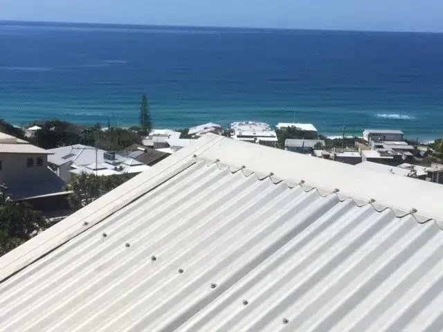 White Corrugated Metal Roof With Ocean View — Over the Top Roofing Specialists in Nambour, QLD