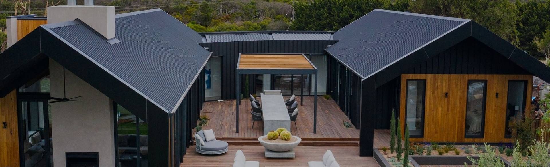 Modern Home With Black Exterior, Wooden Accents — Over the Top Roofing Specialists in Kunda Park, QLD