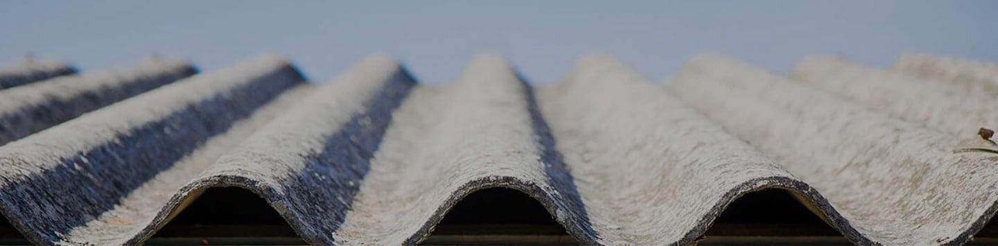 Close-up of Weathered Corrugated Roofing Material Against a Blue Sky — Over the Top Roofing Specialists in Morayfield, QLD