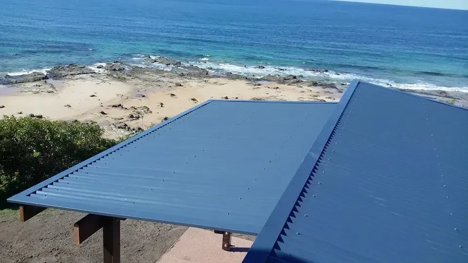 Blue Metal Roof Overlooking a Beach and Ocean — Over the Top Roofing Specialists in Nambour, QLD