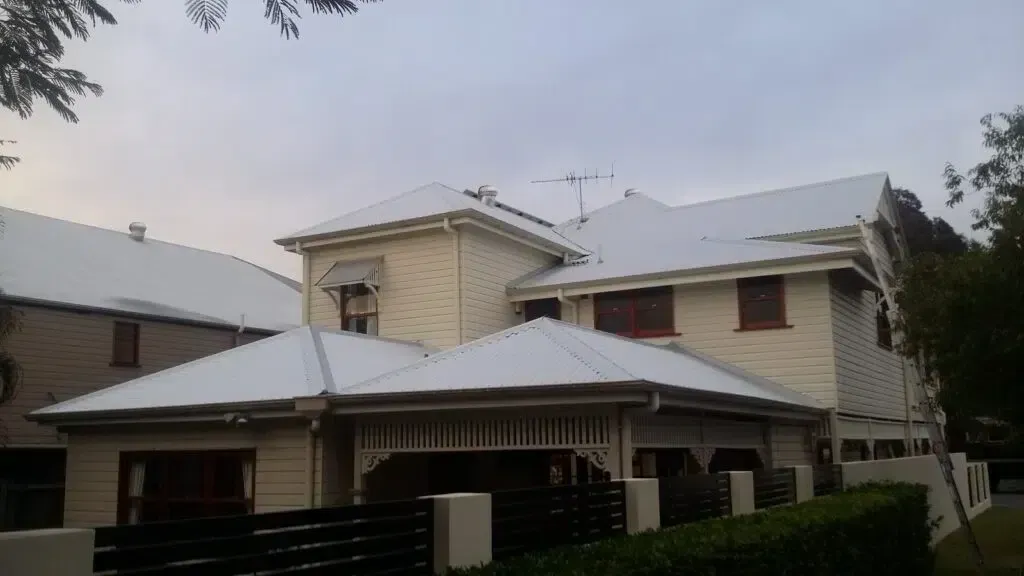 Cream-colored, Two-story House With a White Roof — Over the Top Roofing Specialists in Morayfield, QLD