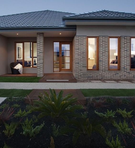 Modern Home Exterior With Brick Facade, Wooden Windows and Door — Over the Top Roofing Specialists in Caboolture, QLD
