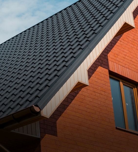 Brick House With Dark Roof and Tan Trim — Over the Top Roofing Specialists in Caboolture, QLD