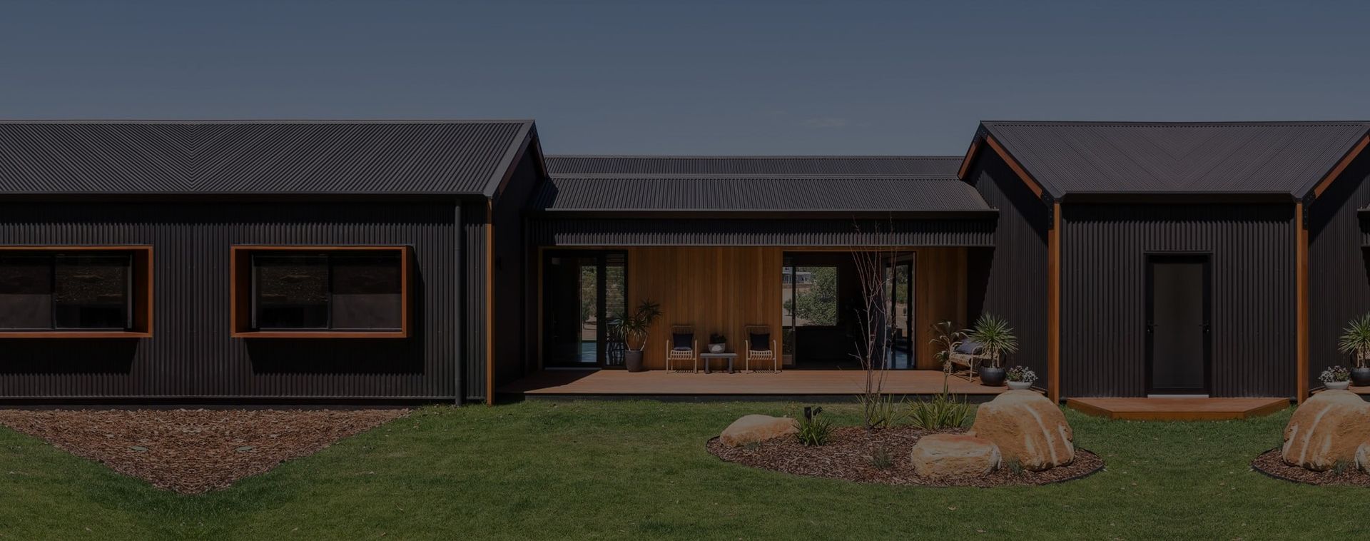 Modern, Black House With a Gabled Roof — Over the Top Roofing Specialists in Nambour, QLD