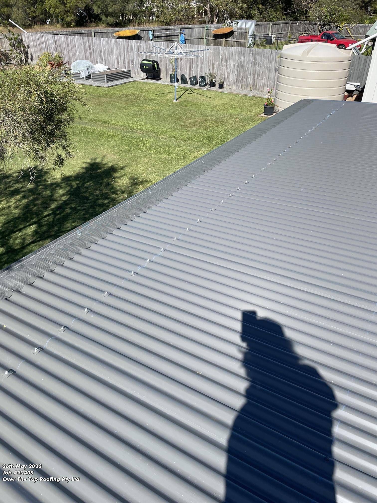 Gray Corrugated Metal Roof With a Backyard View — Over the Top Roofing Specialists in Caboolture, QLD