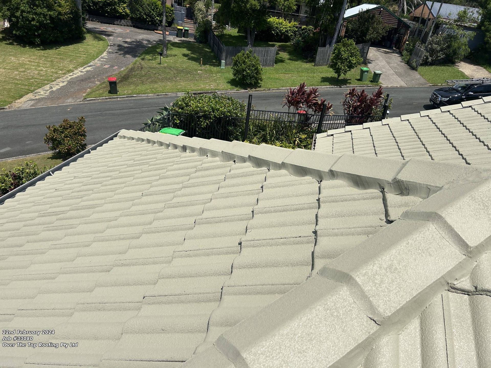 Beige Tiled Roof With a Street View in the Background — Over the Top Roofing Specialists in Buderim, QLD