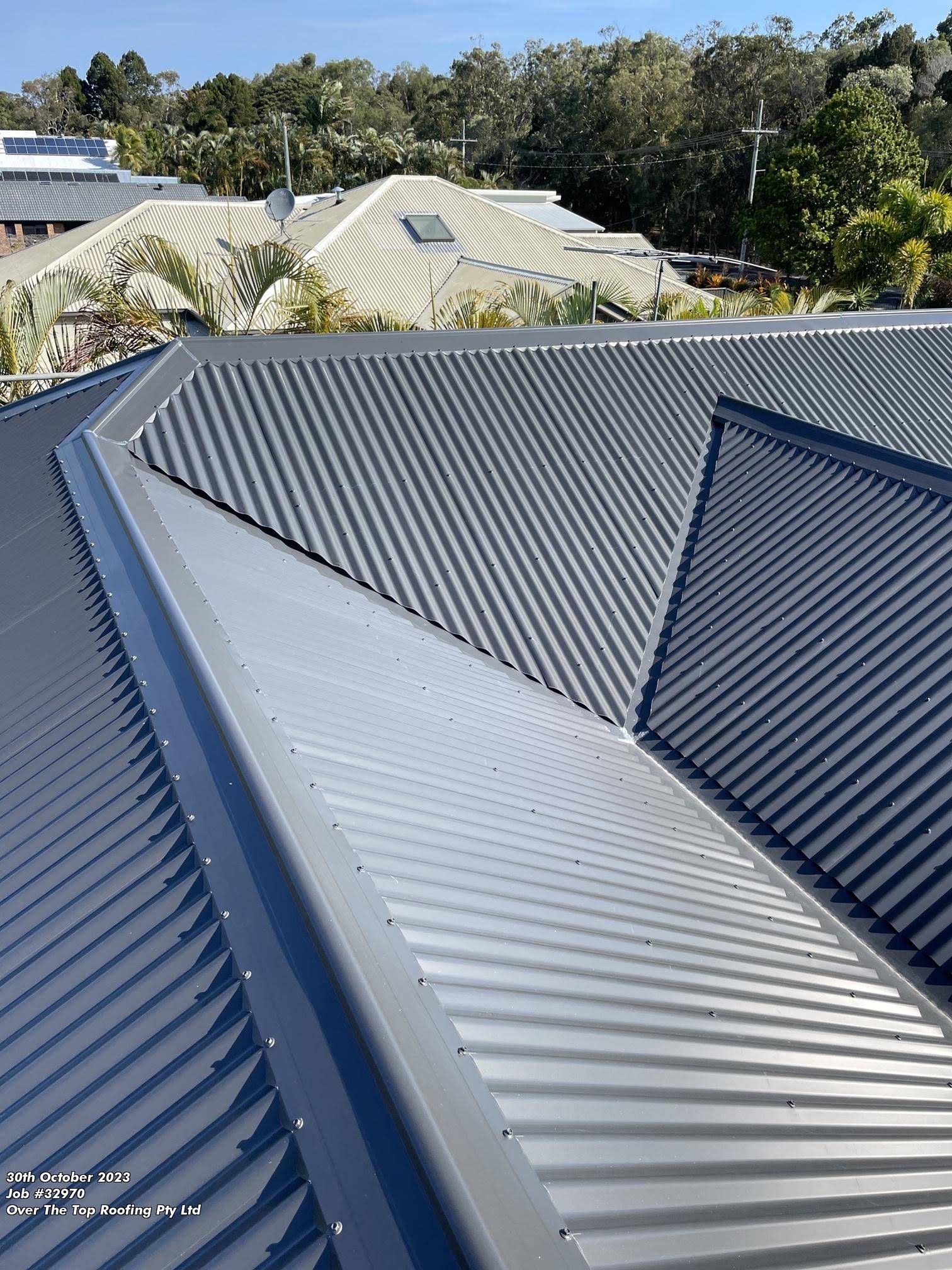 Gray Corrugated Metal Roof on a Building — Over the Top Roofing Specialists in Caloundra, QLD