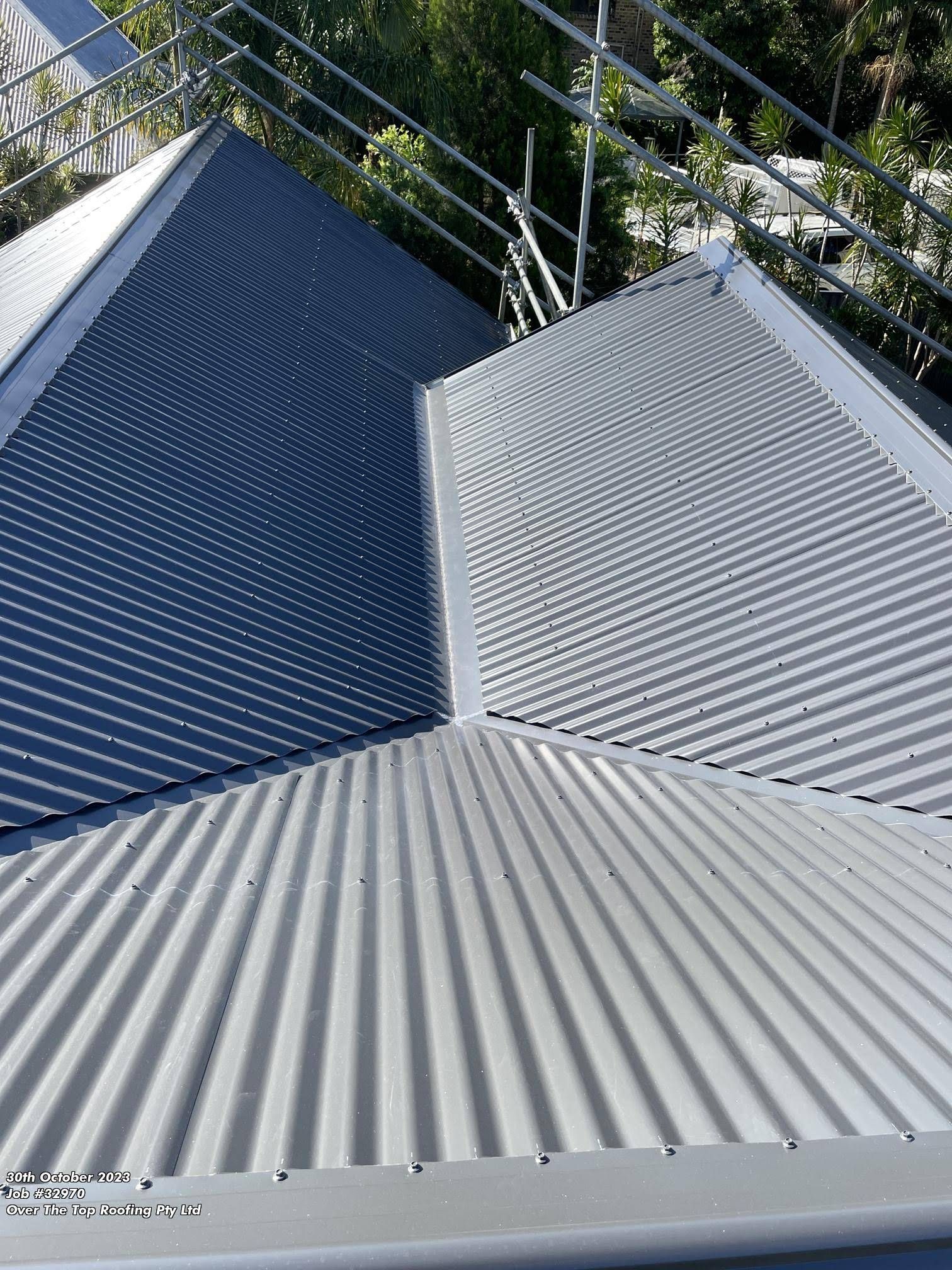 Metal Corrugated Roofing, Two Shades of Gray, With Scaffolding — Over the Top Roofing Specialists in Caloundra, QLD