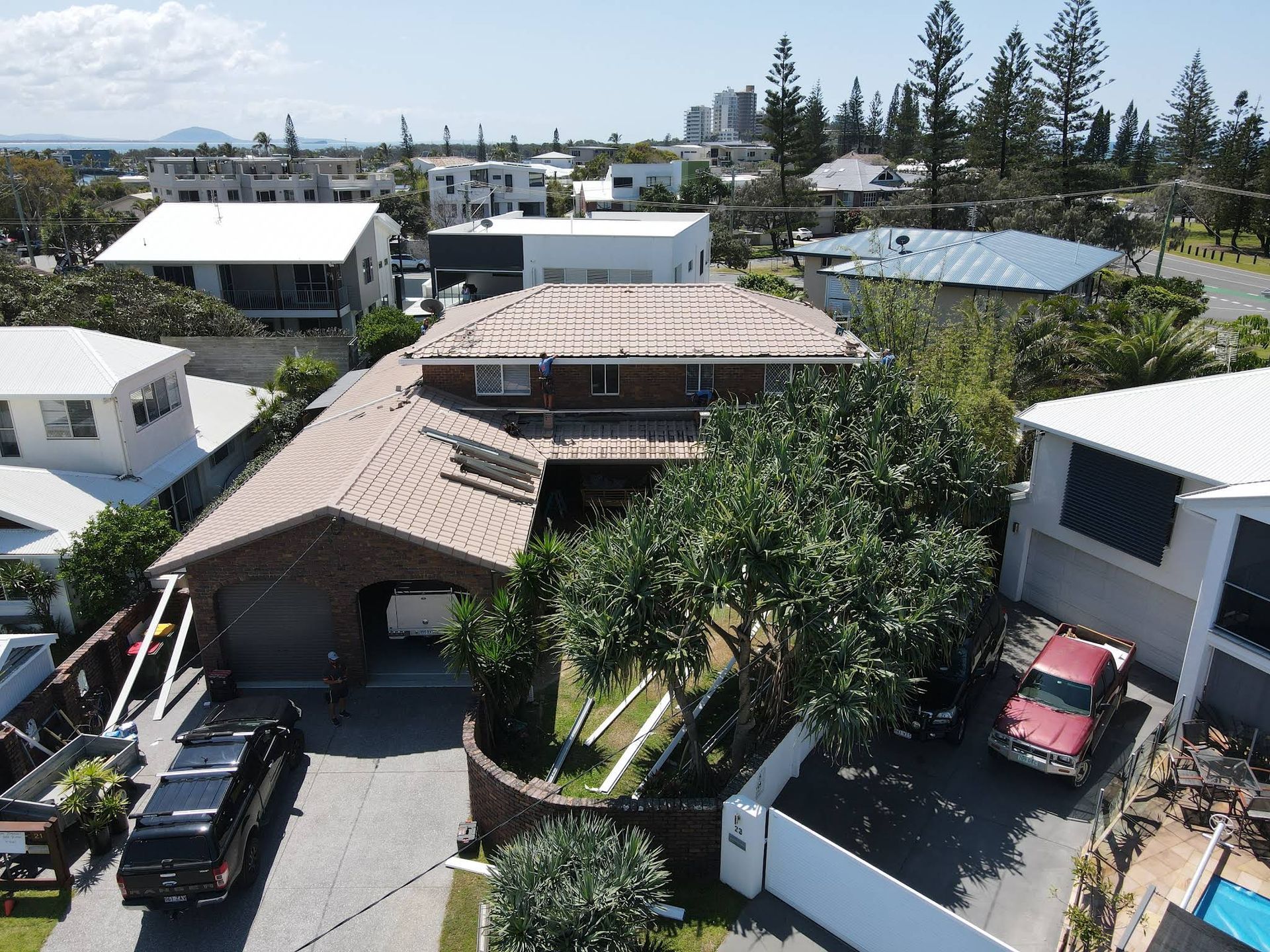 Aerial View of a Roofed House With a Driveway and Houses — Over the Top Roofing Specialists in North Lakes, QLD