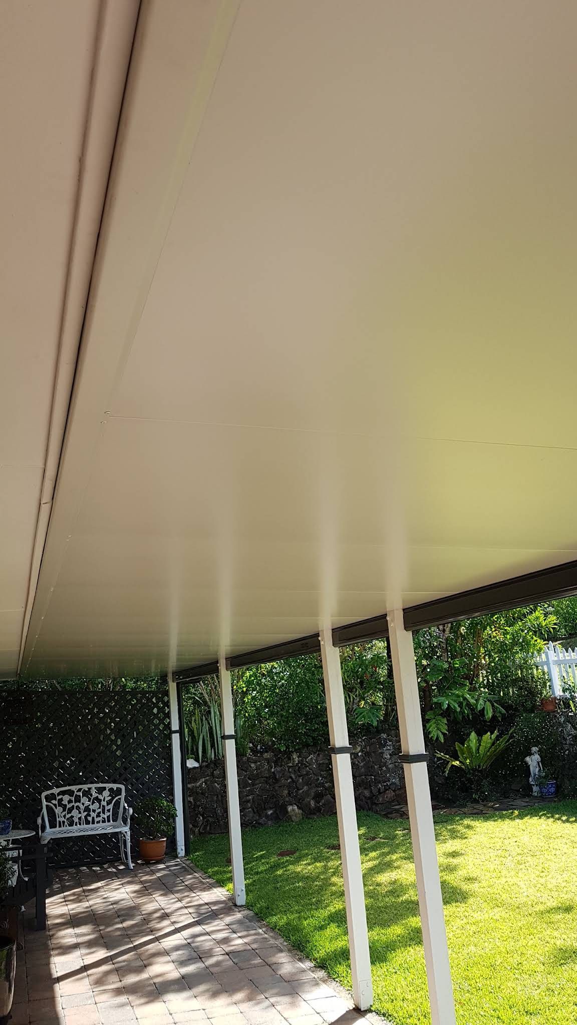 Covered Patio With White Posts and a Cream-colored Ceiling — Over the Top Roofing Specialists in Caboolture, QLD