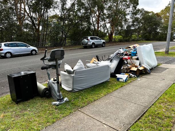 A pile of trash is sitting on the side of the road.