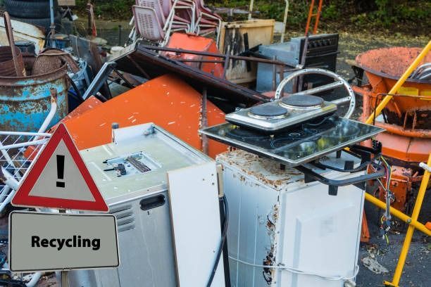 A pile of junk with a recycling sign in the foreground