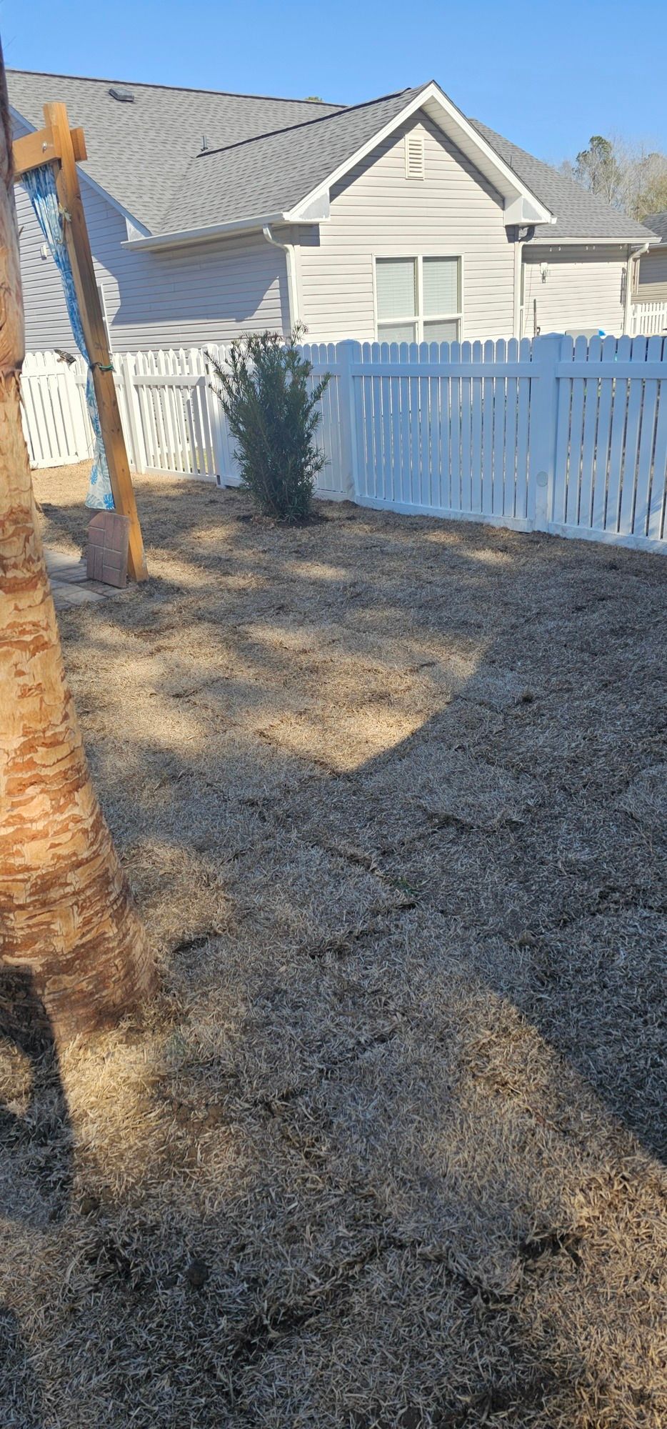 A yellow excavator is sitting on top of a pile of gravel.
