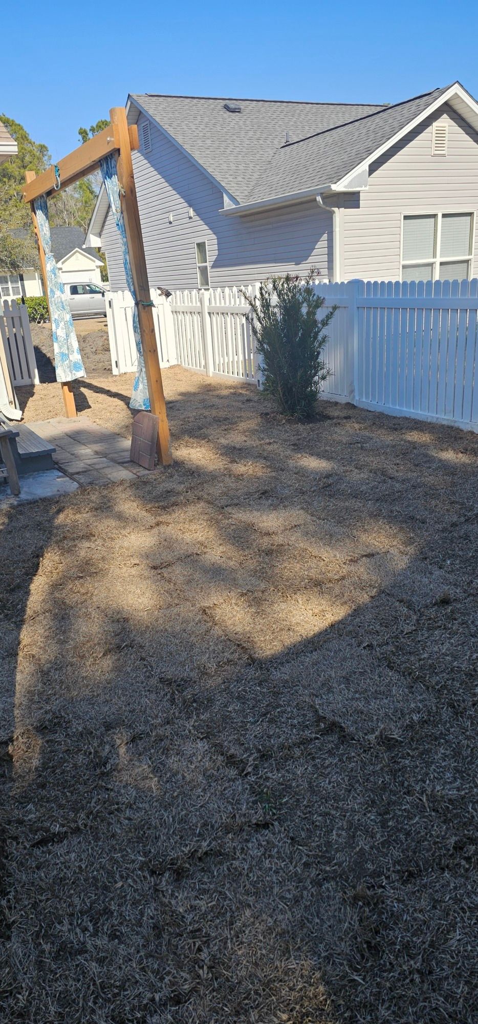 A man wearing a hard hat and goggles is standing in a room.
