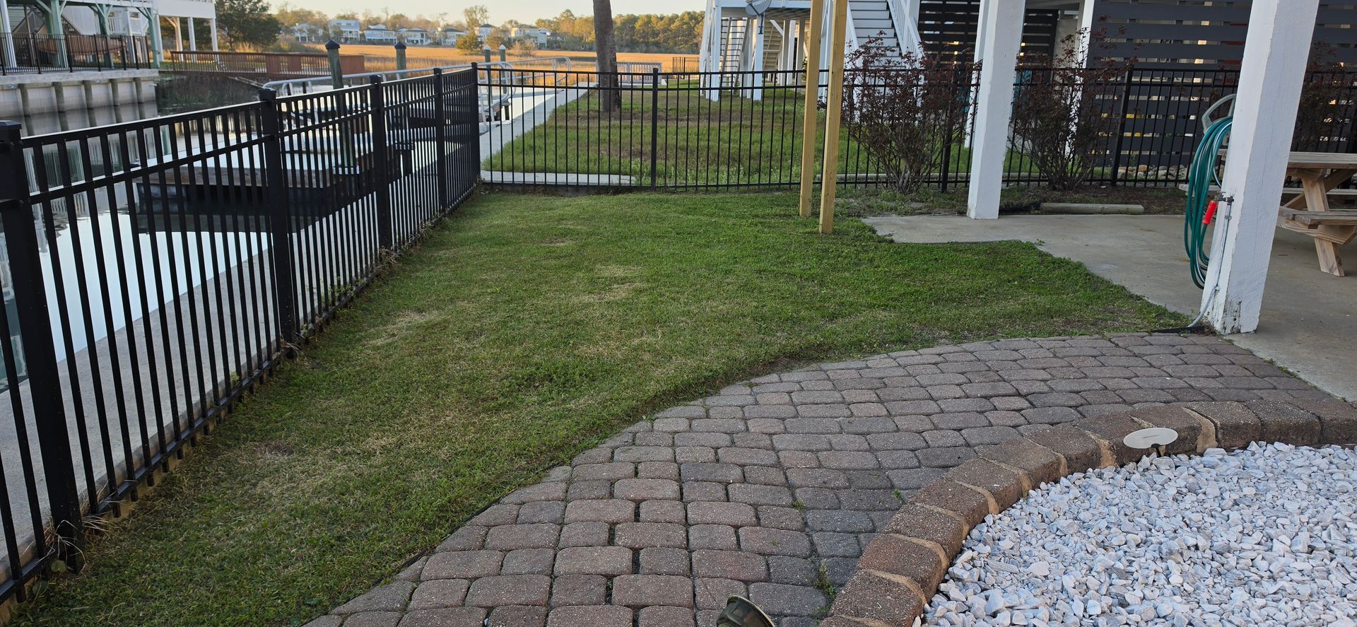 A yellow excavator is sitting on top of a pile of gravel.