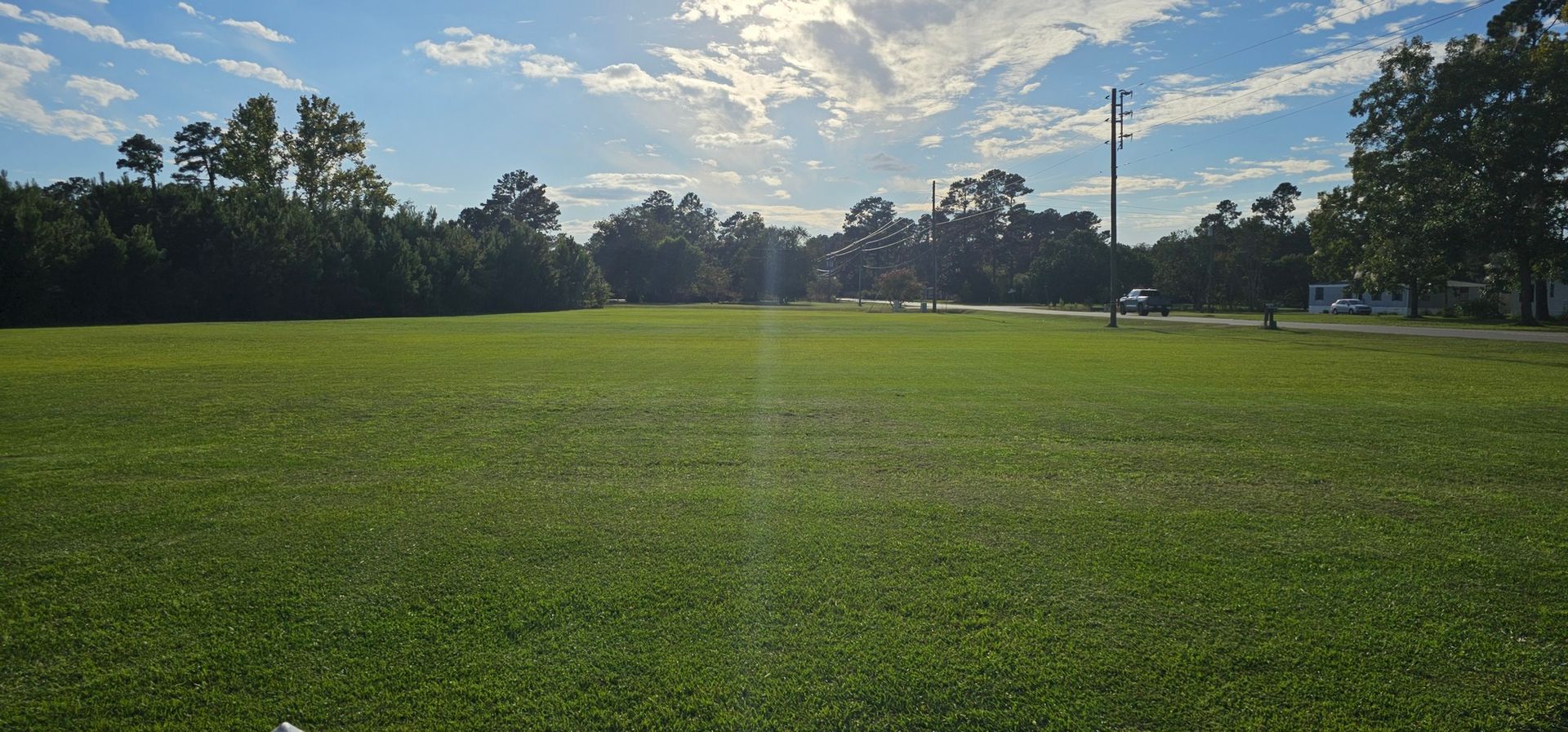 A man wearing a hard hat and goggles is standing in a room.