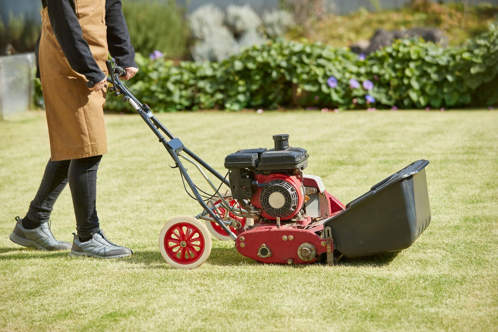 A yellow excavator is sitting on top of a pile of gravel.
