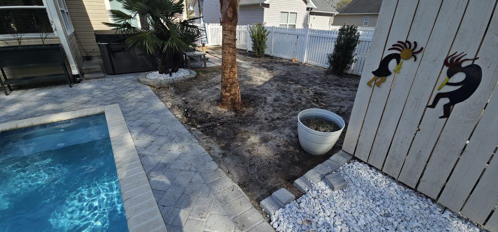 A man wearing a hard hat and goggles is standing in a room.