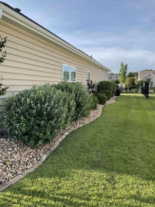 A man wearing a hard hat and goggles is standing in a room.