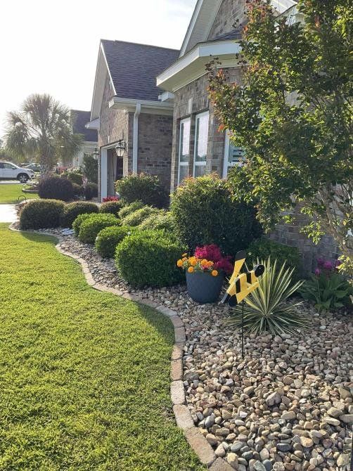 A construction worker wearing a blue hard hat is working on a roof