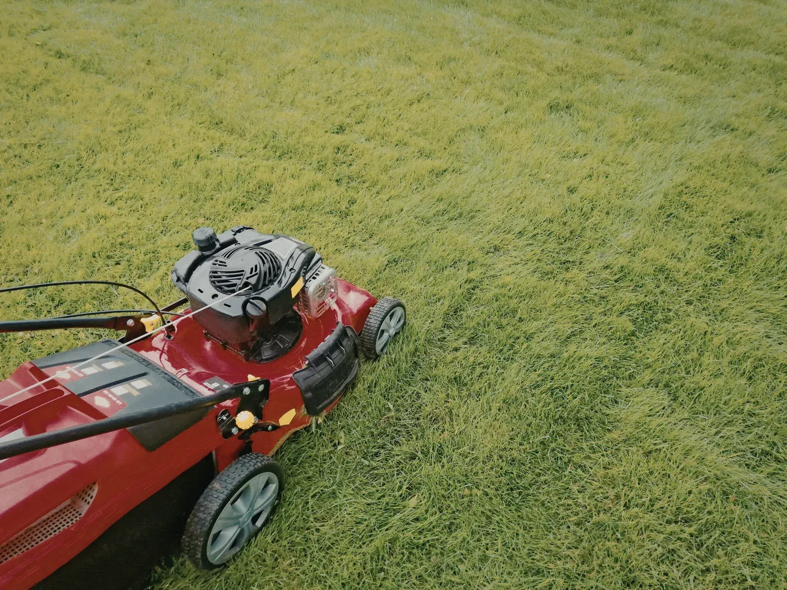 A man wearing a hard hat and goggles is standing in a room.