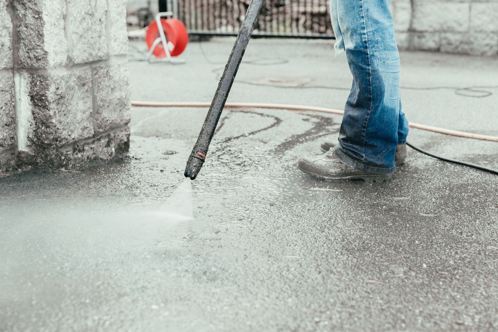 A man wearing a hard hat and goggles is standing in a room.