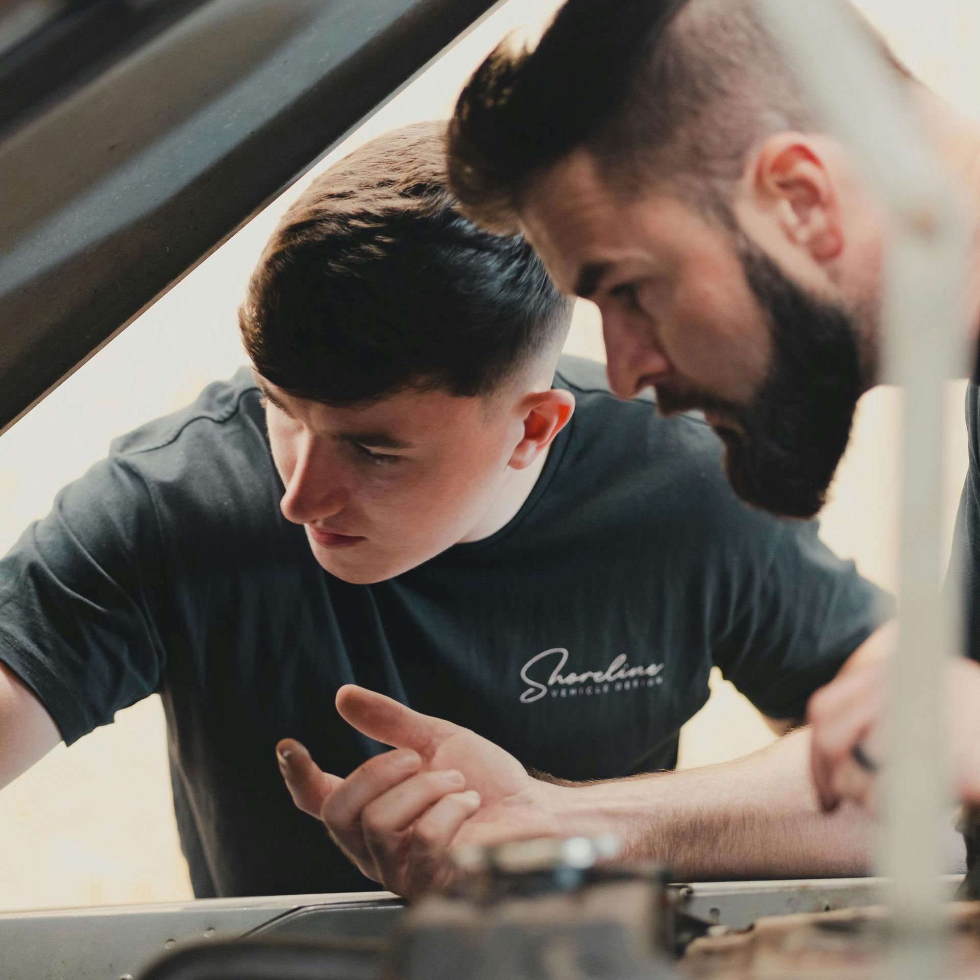 A man leaning on a railing talking on a cell phone