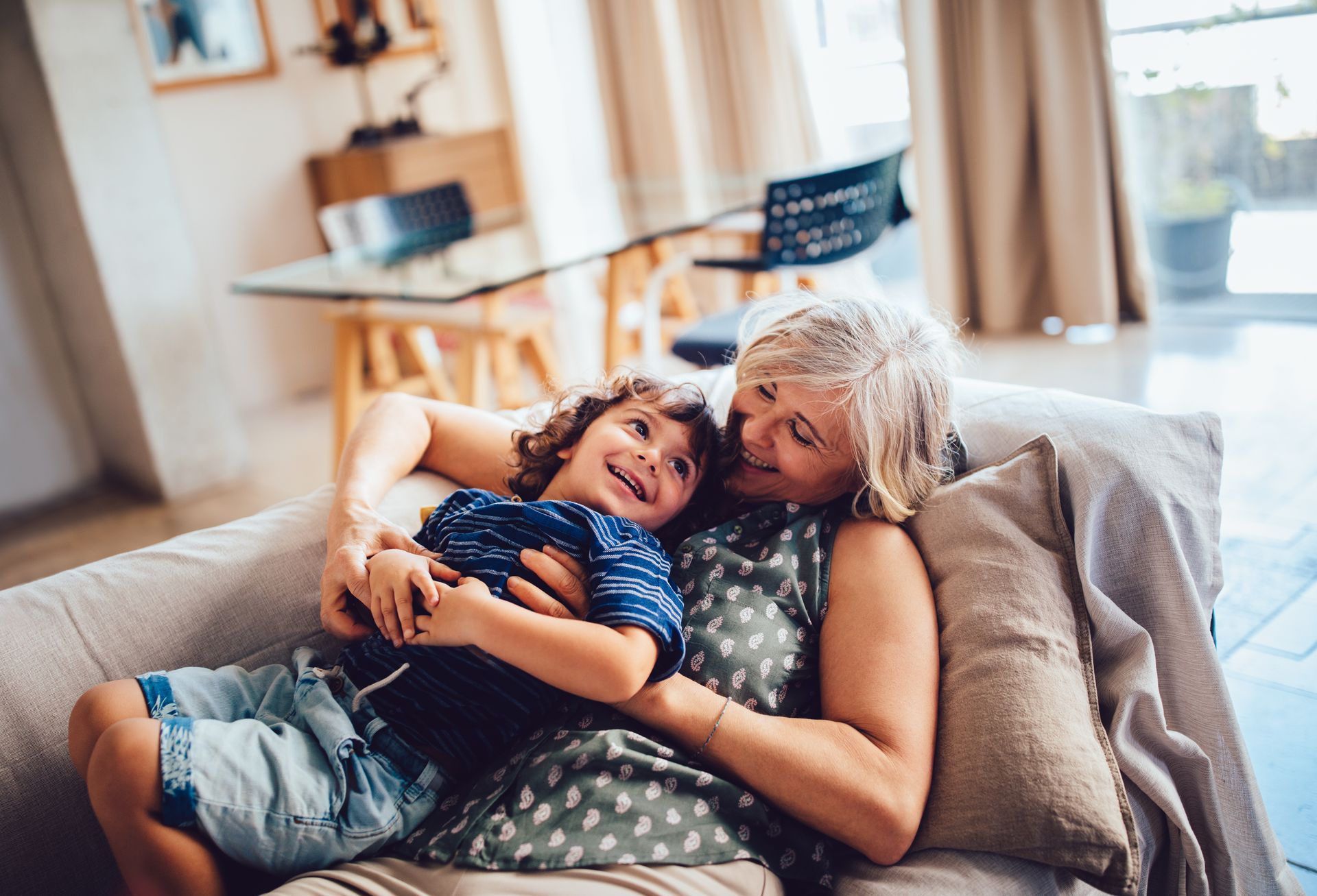 A woman and a child are sitting on a couch.