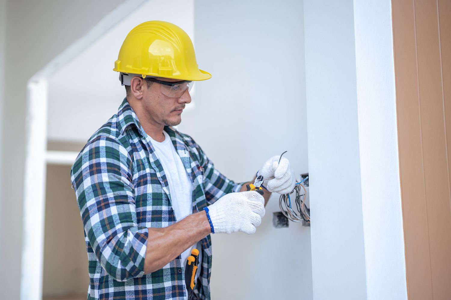 Licensed electrician installing new wiring in a residential property.